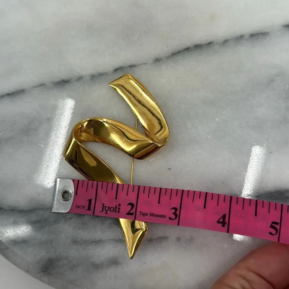 Vintage monet gold ribbon swoosh brooch